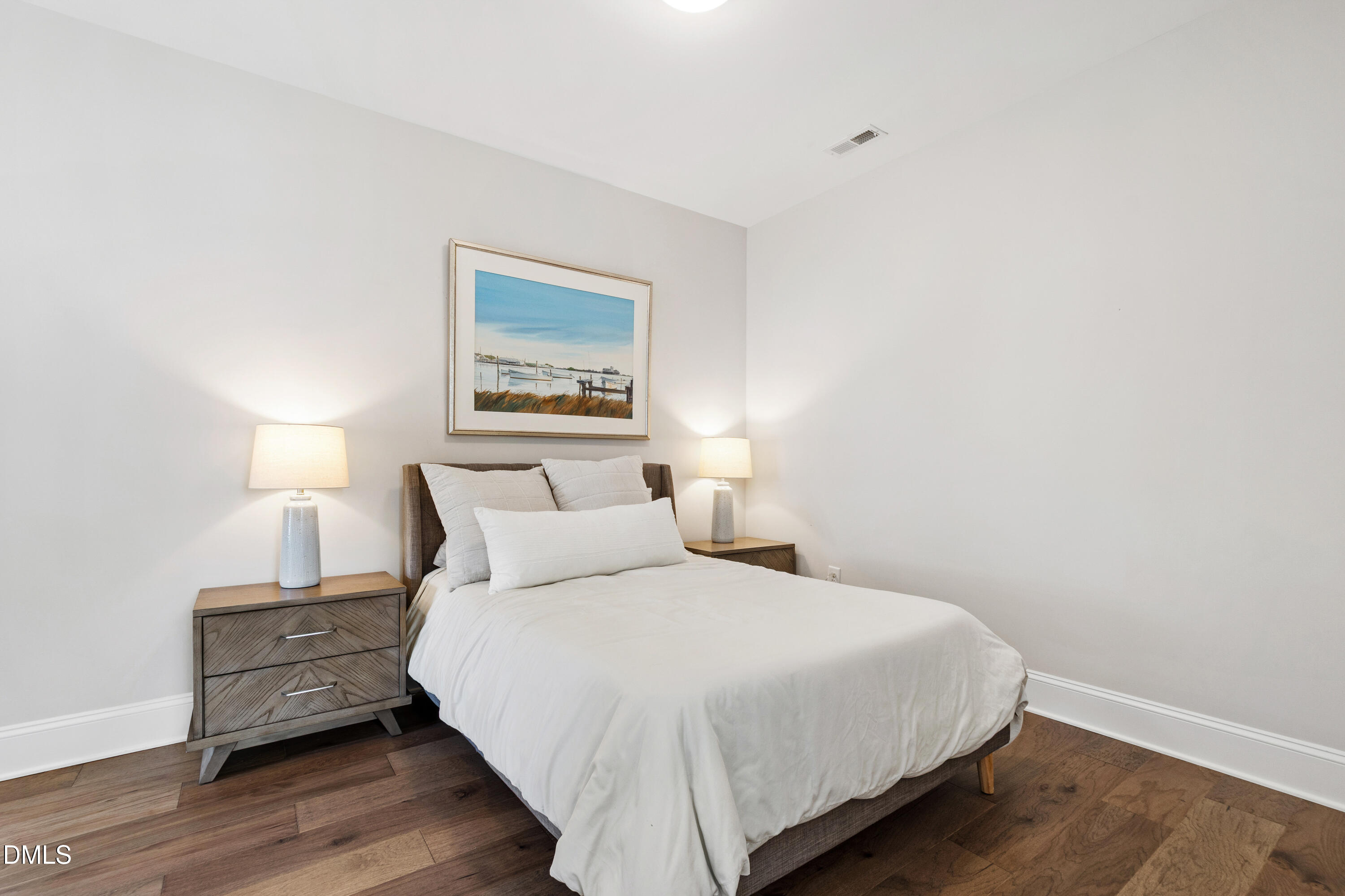 4934 Trek Lane Raleigh, NC 27606 - Photo 25 of 35 a bedroom with a bed and wooden floor