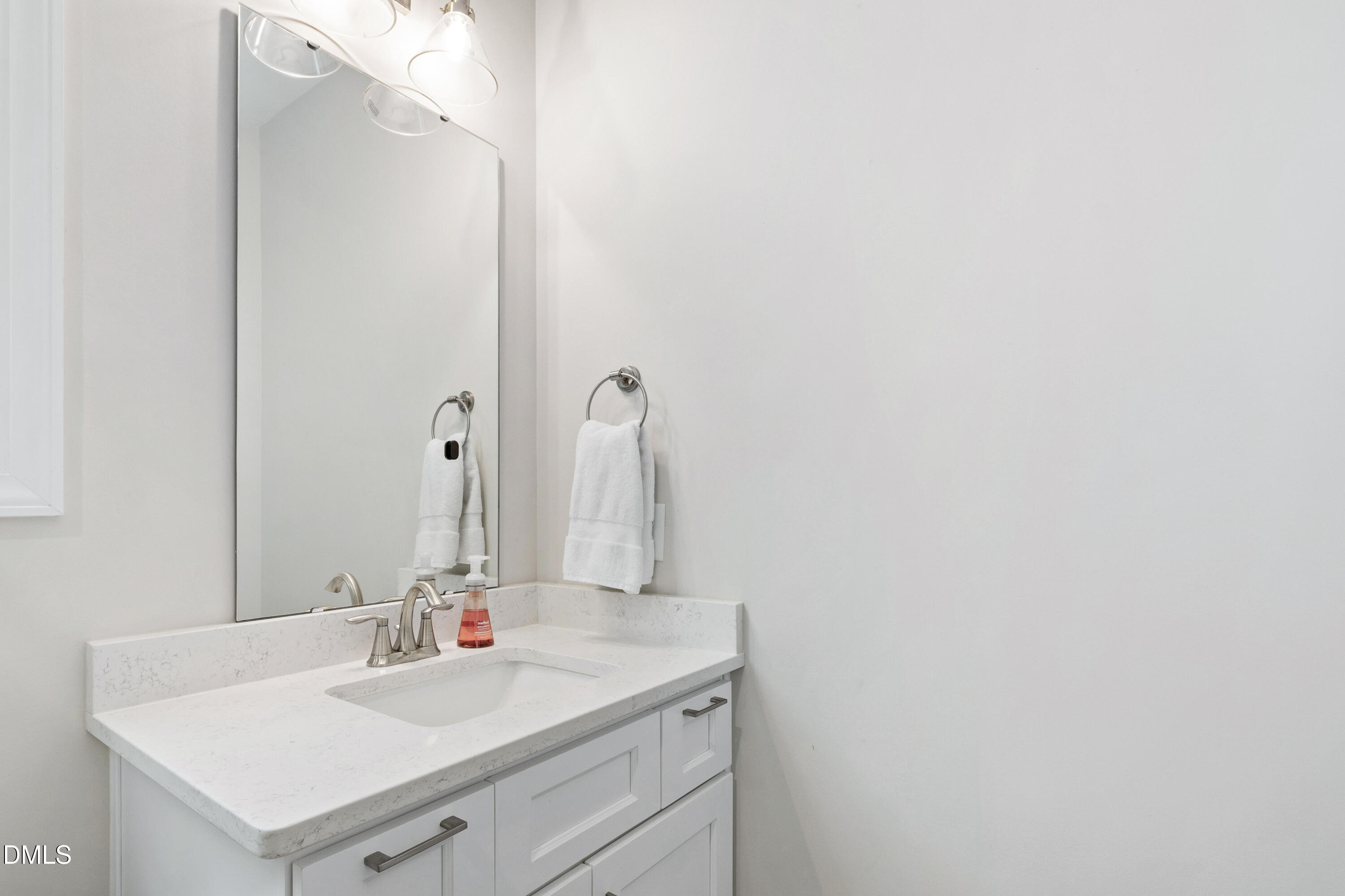 4934 Trek Lane Raleigh, NC 27606 - Photo 29 of 35 a bathroom with a sink and a mirror
