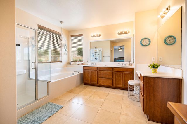 a large bathroom with a tub a sink a mirror and a shower