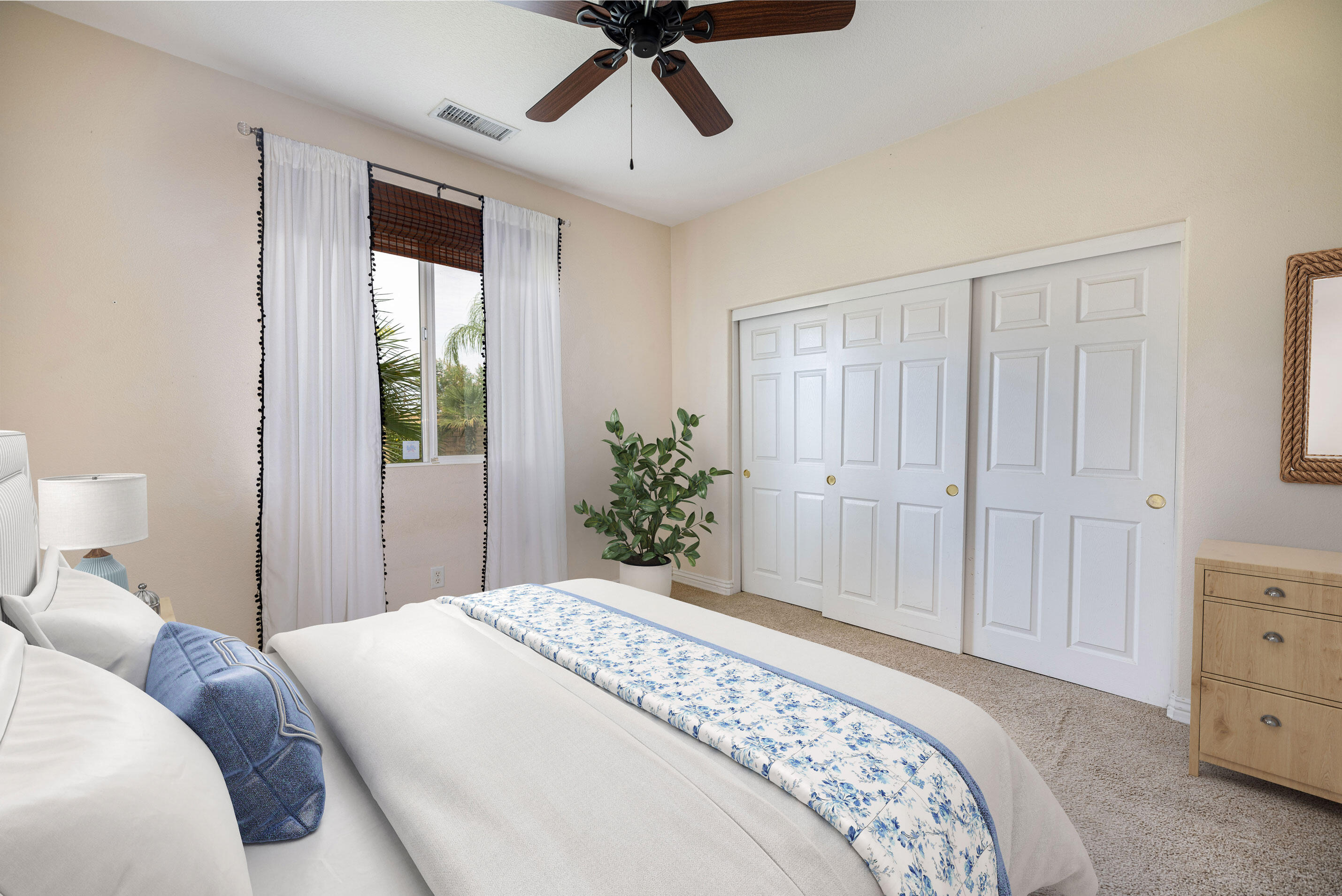 80292 Whitehaven Drive Indio, CA 92203 - Photo 13 of 25 a bedroom with a large bed and chandelier