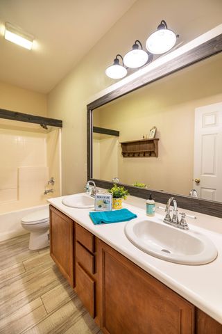 a bathroom with a double vanity sink and a mirror