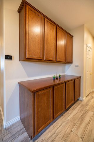a kitchen with wooden cabinets