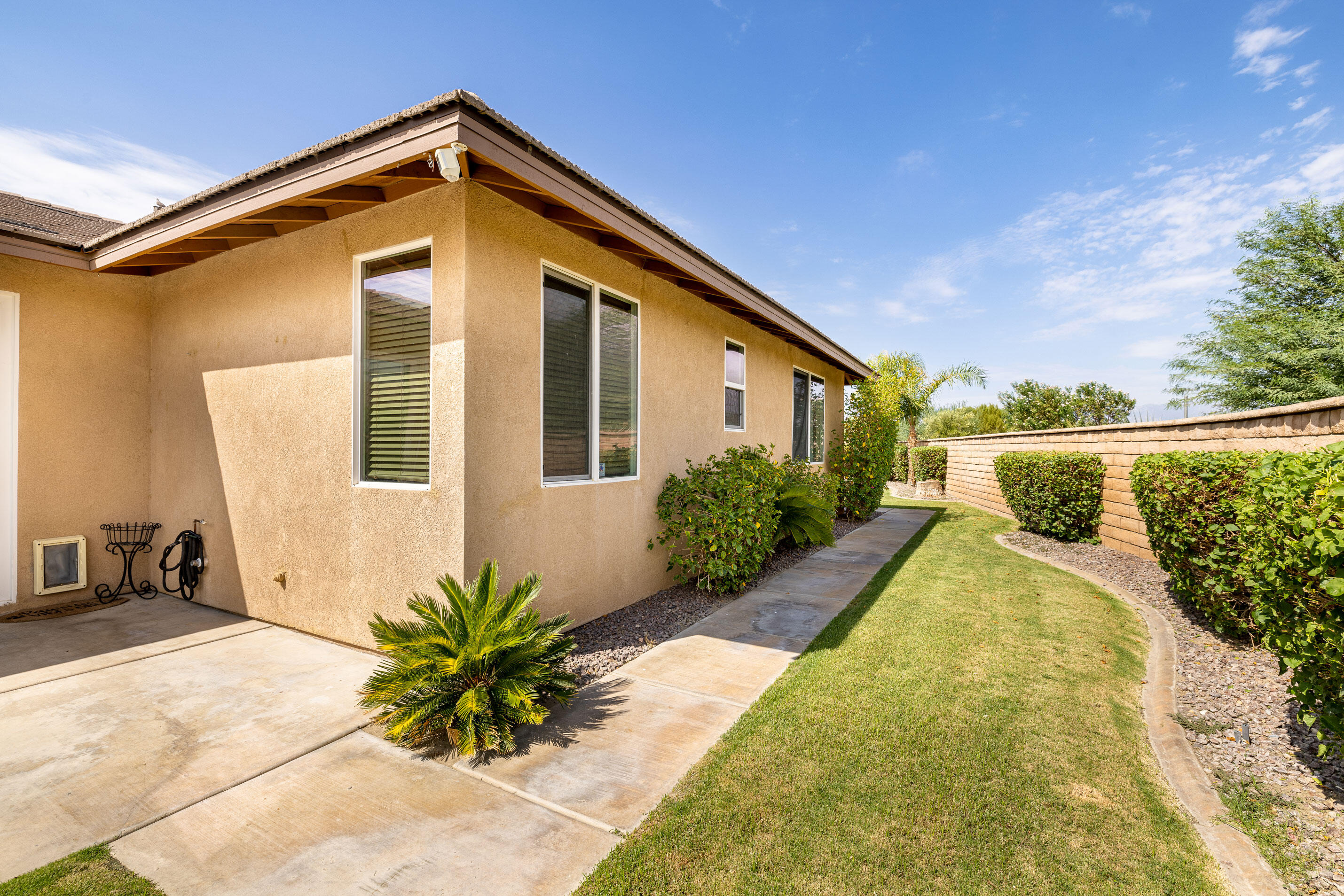 80292 Whitehaven Drive Indio, CA 92203 - Photo 19 of 25 a front view of a house with a yard