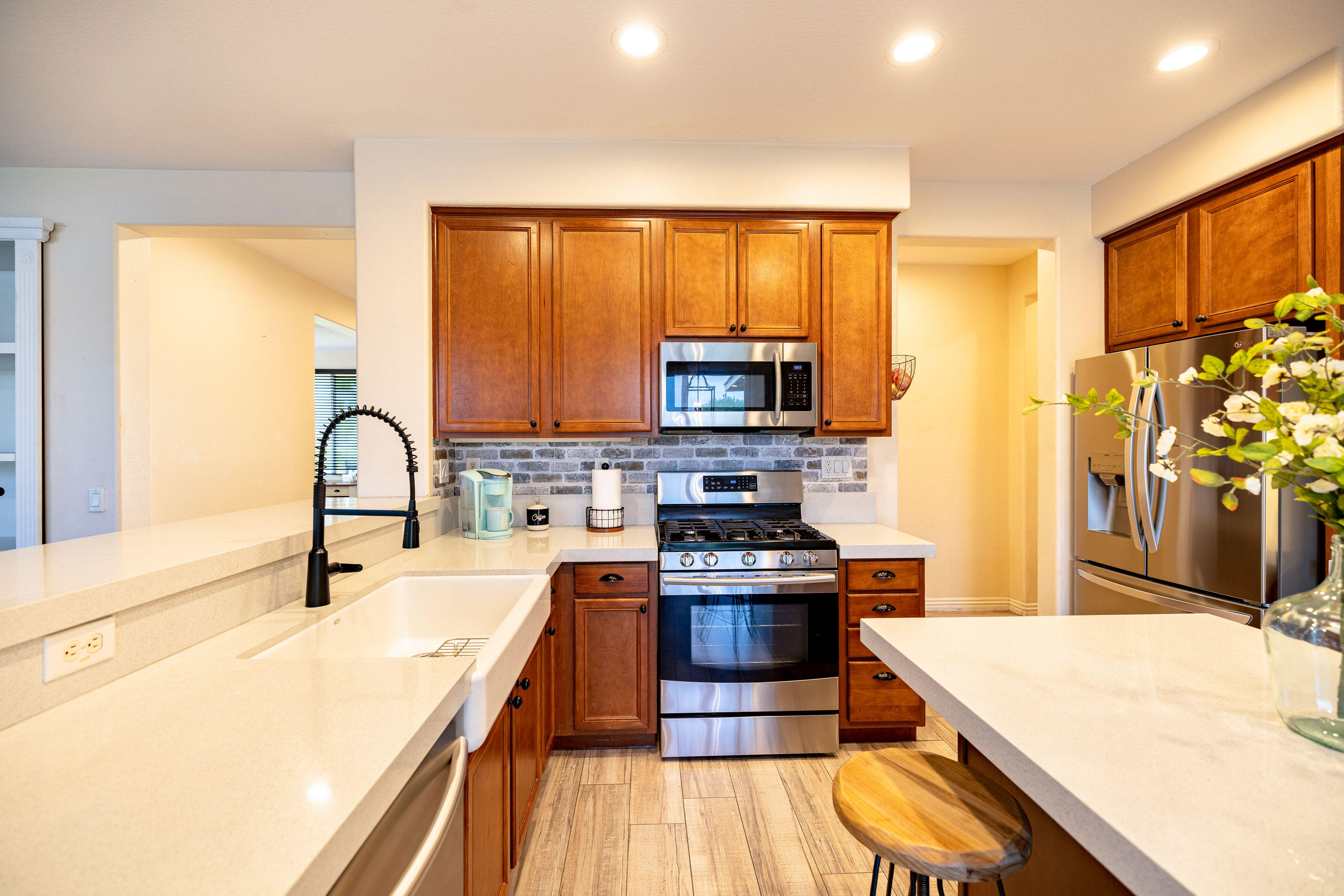 80292 Whitehaven Drive Indio, CA 92203 - Photo 6 of 25 a kitchen with stainless steel appliances a stove sink and cabinets