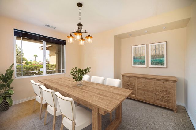 a view of a dining room with furniture window and outside view