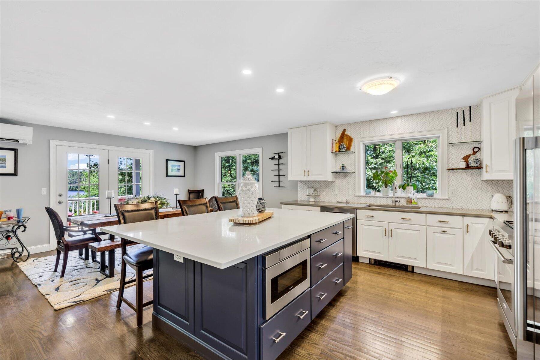 1 Ravens Nest Road Sandwich, MA 02563 - Photo 7 of 46 a kitchen with a stove a sink a dining table and chairs