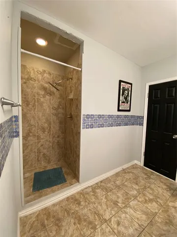 a bathroom with a shower and a sink