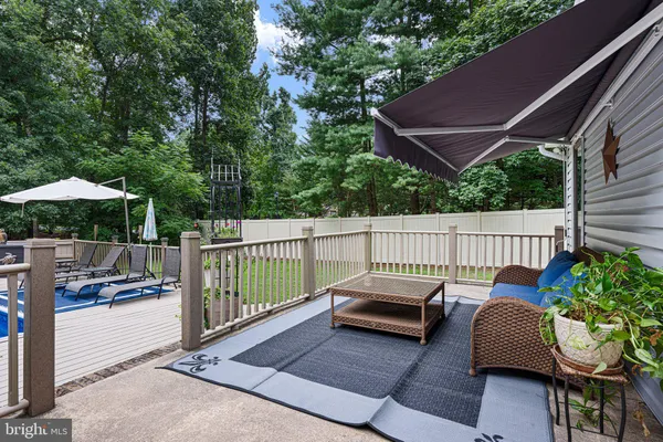 a view of a patio with furniture and a backyard