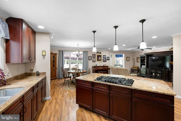 a kitchen with stainless steel appliances granite countertop a sink and a stove