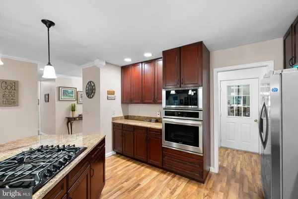 a kitchen with stainless steel appliances granite countertop a stove and a refrigerator
