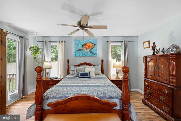 a bedroom with furniture and a flat screen tv