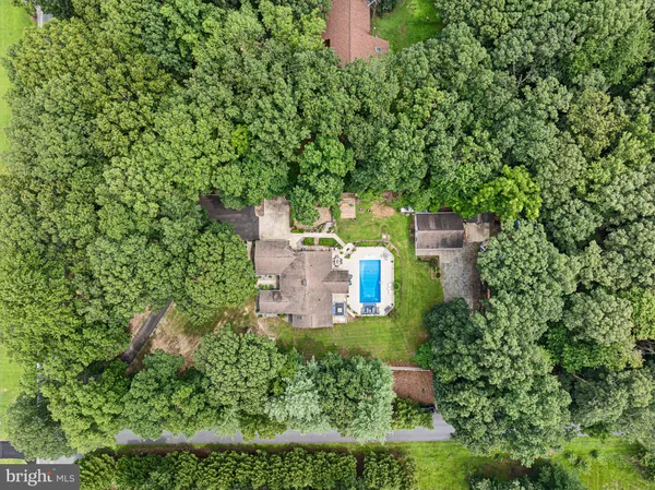 an aerial view of a house with a yard and plants