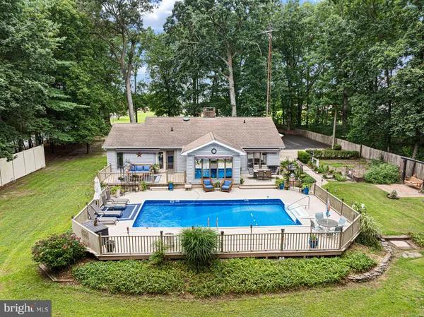 an aerial view of a house with swimming pool and big yard