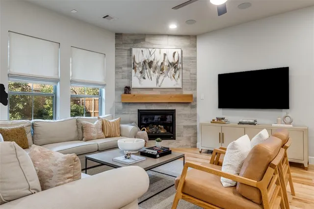a living room with furniture fireplace and flat screen tv