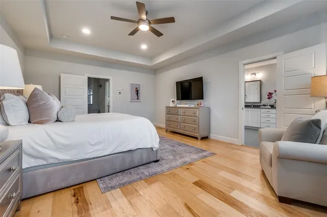 a bedroom with a large bed and a flat screen tv