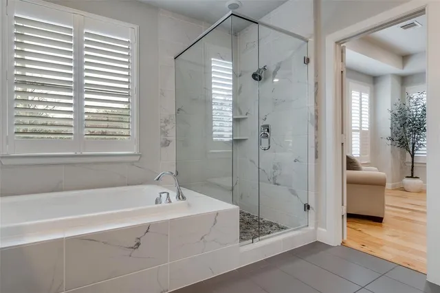 a spacious bathroom with a bathtub and a shower