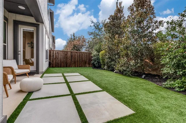 a backyard of a house with table and chairs