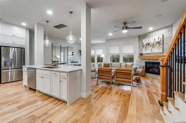 a open kitchen with white cabinets and stainless steel appliances