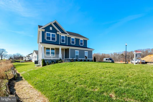 a view of a house with a yard and sitting area