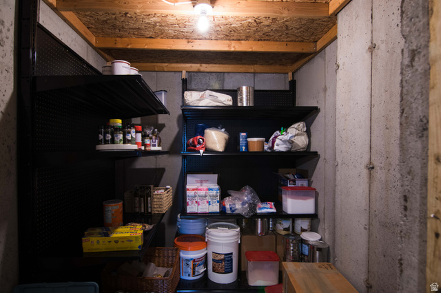 646 East 1400th Street North Mapleton, UT 84664 - Photo 60 of 78 Utility storage area featuring concrete walls, exposed wood ceiling joists, and installed shelving units