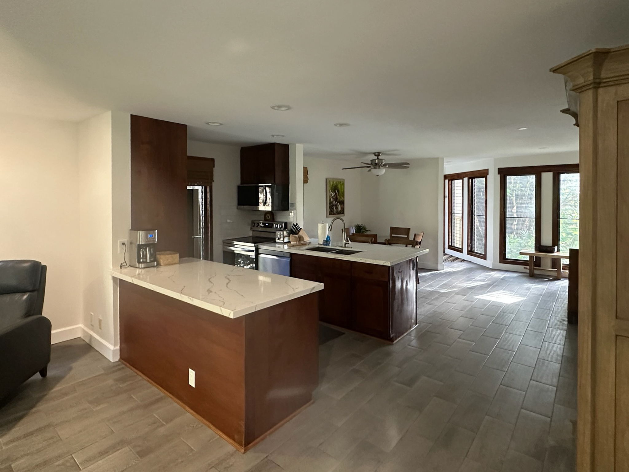 a view living room with kitchen island stainless steel appliances wooden floor and living room view
