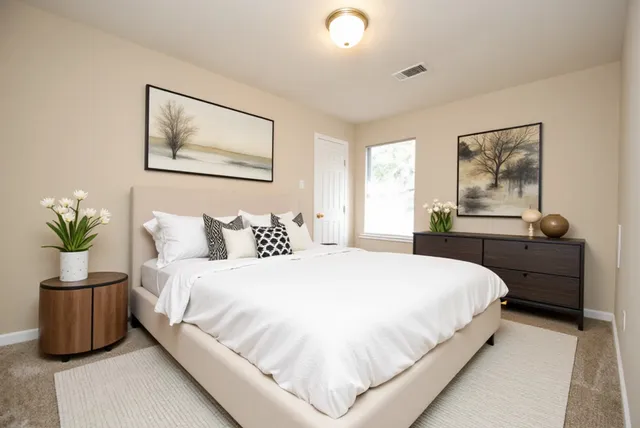 a bathroom with a double vanity sink toilet and a mirror