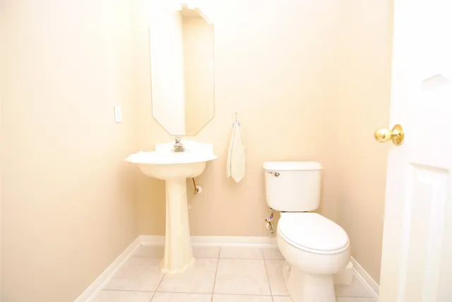 a living room with patio furniture and a potted plants