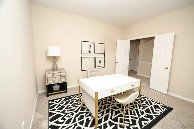 a living room with a rug and a table