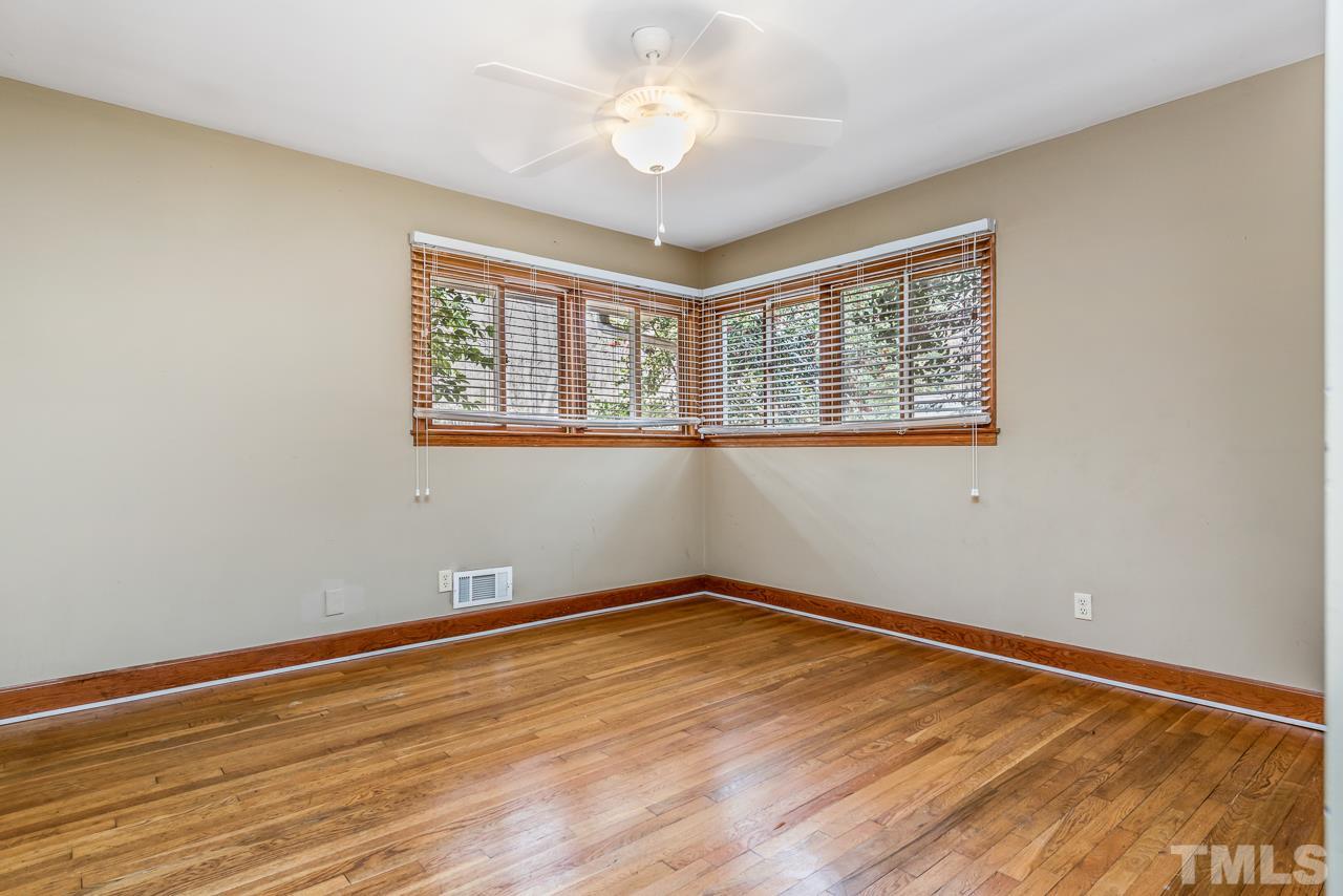 10217 Creedmoor Road Raleigh, NC 27615 - Photo 11 of 24 a view of empty room with wooden floor and fan