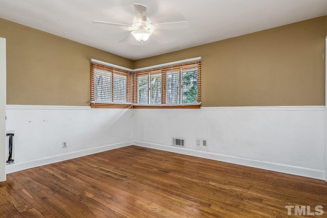 10217 Creedmoor Road Raleigh, NC 27615 - Photo 12 of 24 a view of empty room with wooden floor and fan