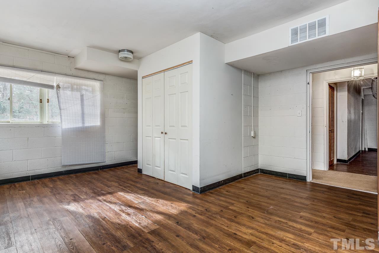 10217 Creedmoor Road Raleigh, NC 27615 - Photo 16 of 24 an empty room with wooden floor and windows