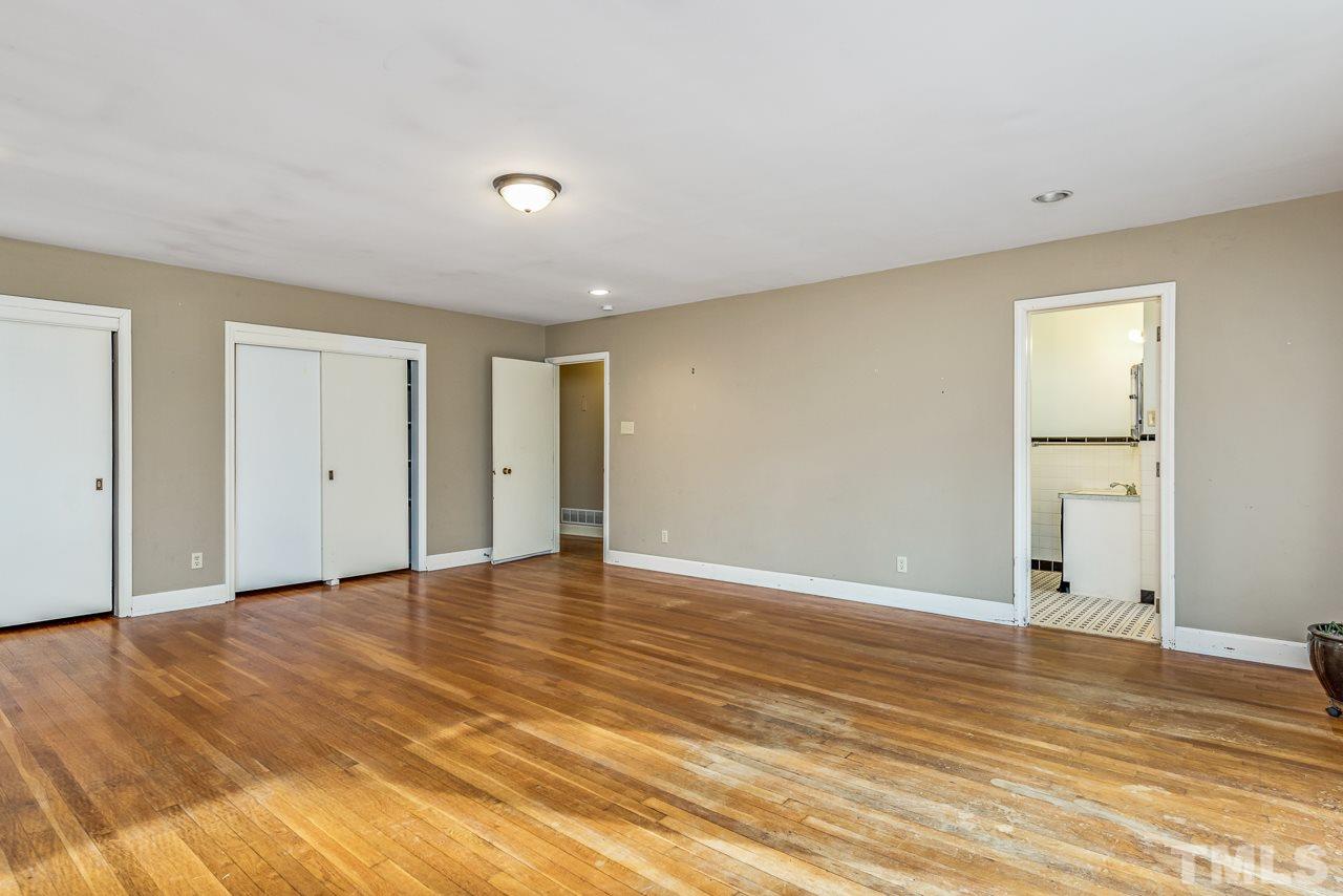 10217 Creedmoor Road Raleigh, NC 27615 - Photo 19 of 24 a view of an empty room with wooden floor