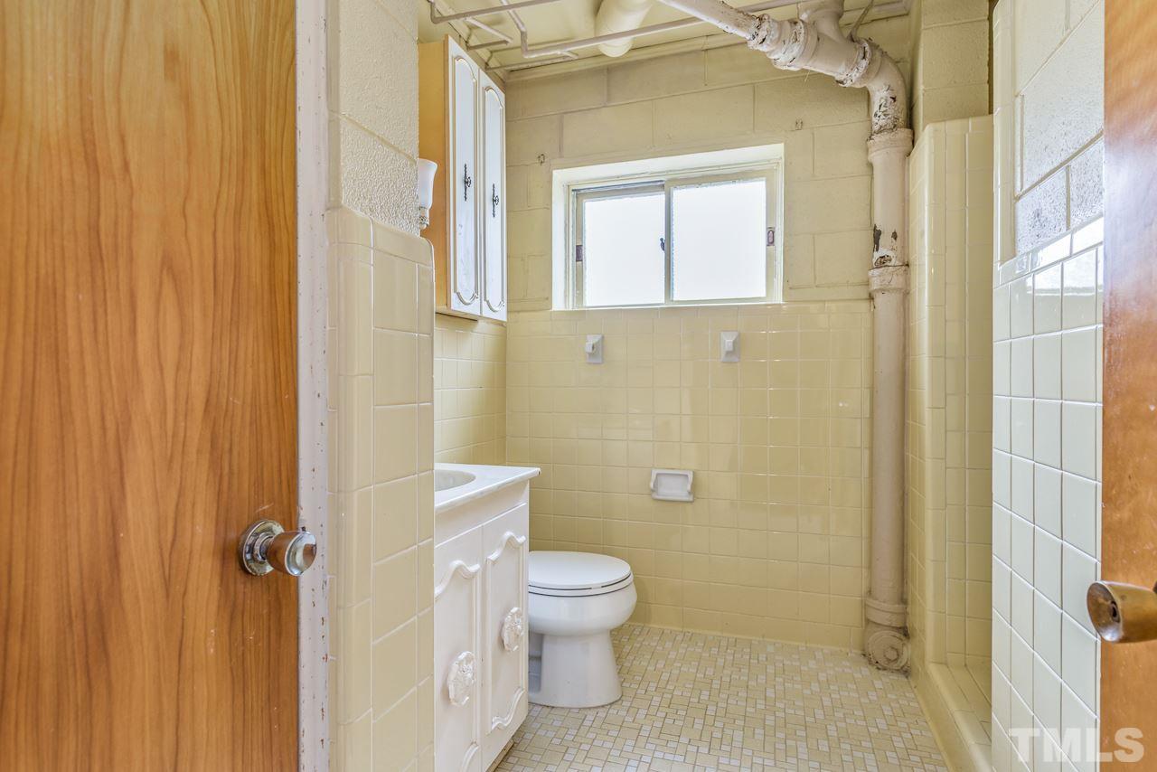 10217 Creedmoor Road Raleigh, NC 27615 - Photo 20 of 24 a bathroom with a toilet and a shower