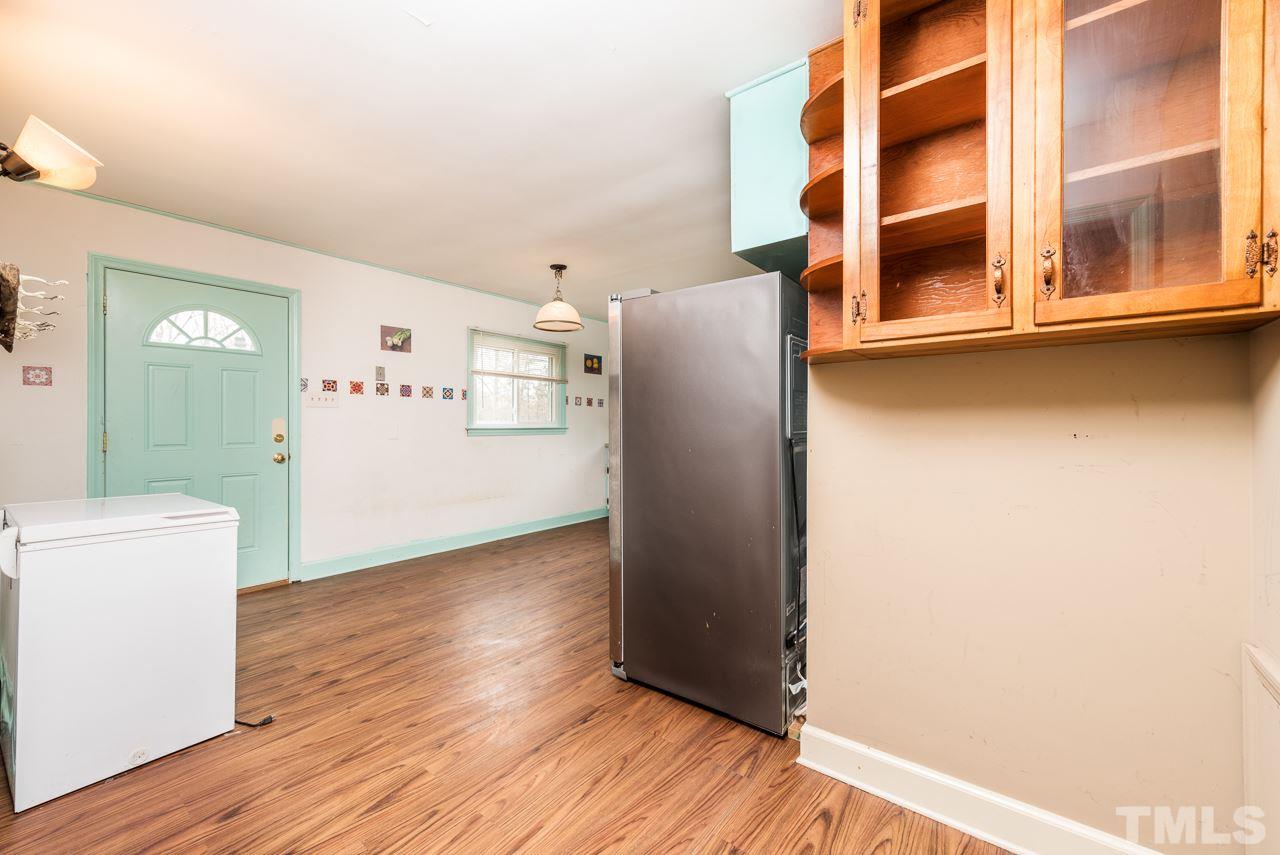 10217 Creedmoor Road Raleigh, NC 27615 - Photo 4 of 24 an empty room with wooden floor and windows
