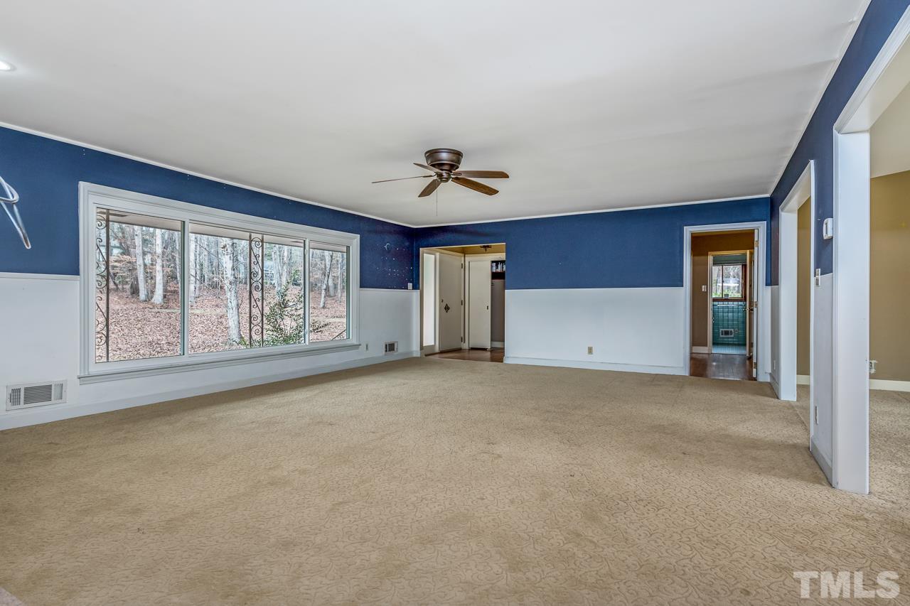 10217 Creedmoor Road Raleigh, NC 27615 - Photo 6 of 24 a view of an empty room with a window