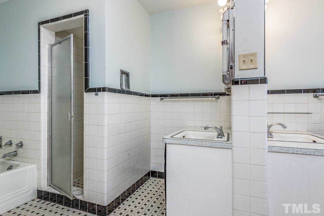 10217 Creedmoor Road Raleigh, NC 27615 - Photo 7 of 24 a bathroom with a sink a toilet and shower