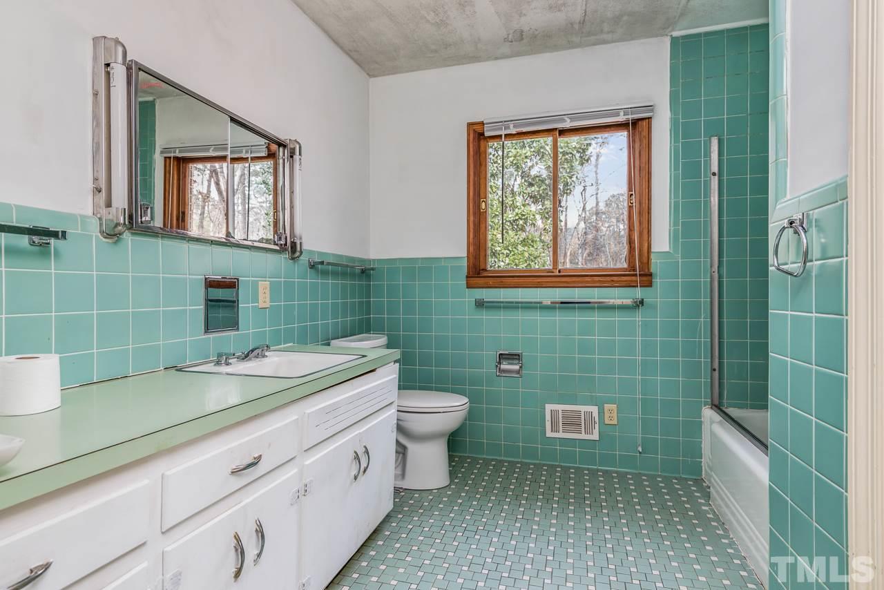 10217 Creedmoor Road Raleigh, NC 27615 - Photo 10 of 24 a bathroom with a sink a toilet and mirror