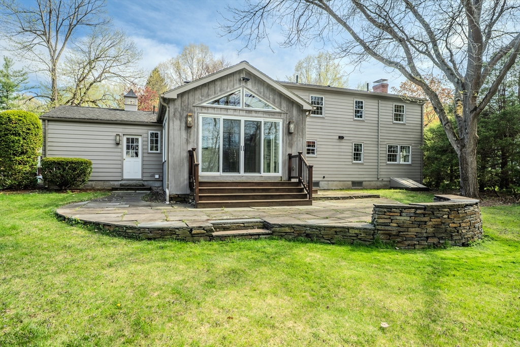 199 Glendale Road Amherst, MA 01002 - Photo 11 of 42 a view of a house with a small yard plants and large trees