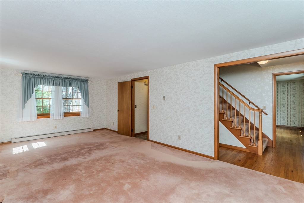199 Glendale Road Amherst, MA 01002 - Photo 18 of 42 a view of an empty room with window and stairs