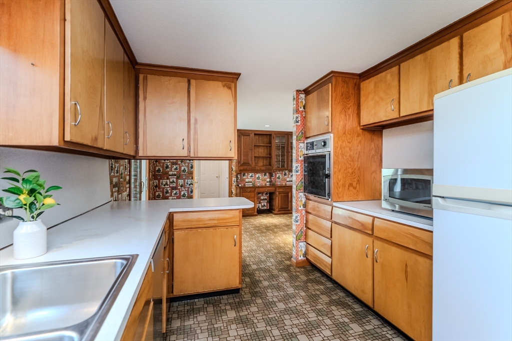 199 Glendale Road Amherst, MA 01002 - Photo 22 of 42 a kitchen with stainless steel appliances granite countertop a sink stove and cabinets