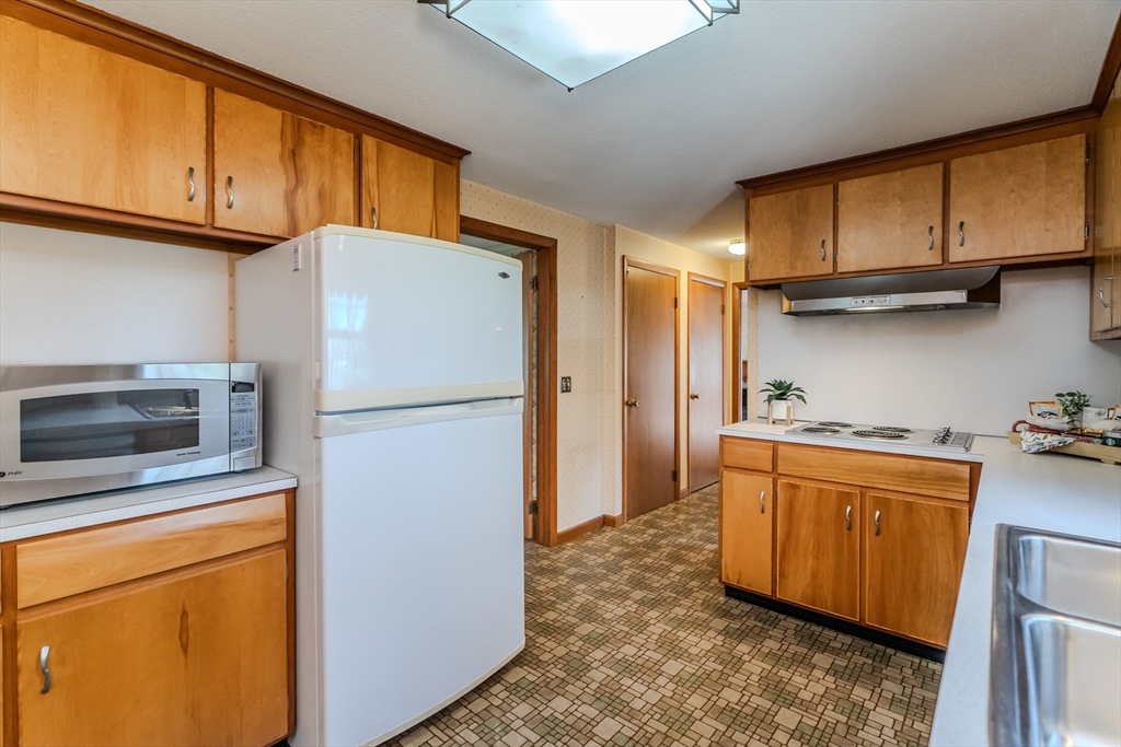 199 Glendale Road Amherst, MA 01002 - Photo 24 of 42 a kitchen with stainless steel appliances a refrigerator stove and microwave