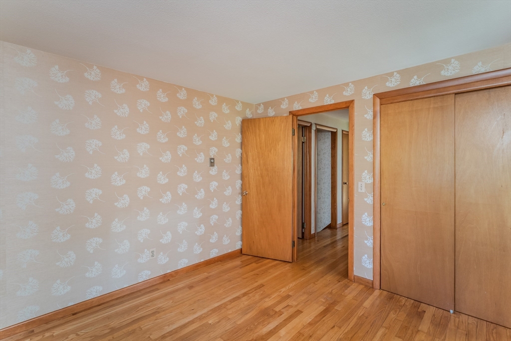 199 Glendale Road Amherst, MA 01002 - Photo 35 of 42 a view of an empty room with wooden floor and a window