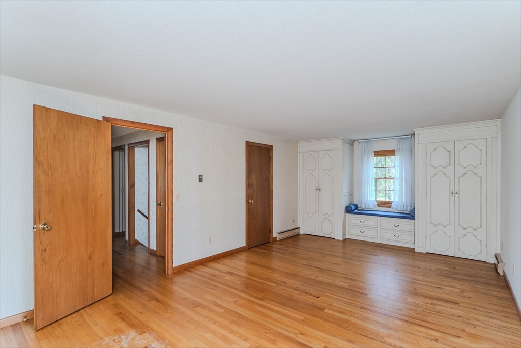 199 Glendale Road Amherst, MA 01002 - Photo 36 of 42 an empty room with wooden floor and windows