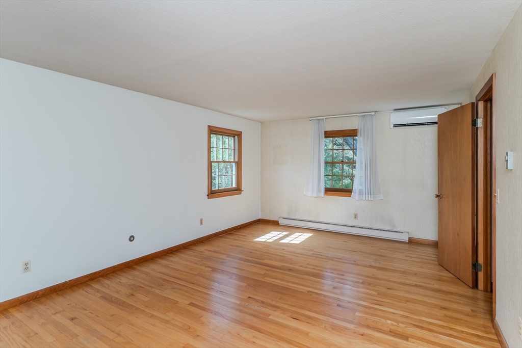 199 Glendale Road Amherst, MA 01002 - Photo 38 of 42 an empty room with wooden floor and windows