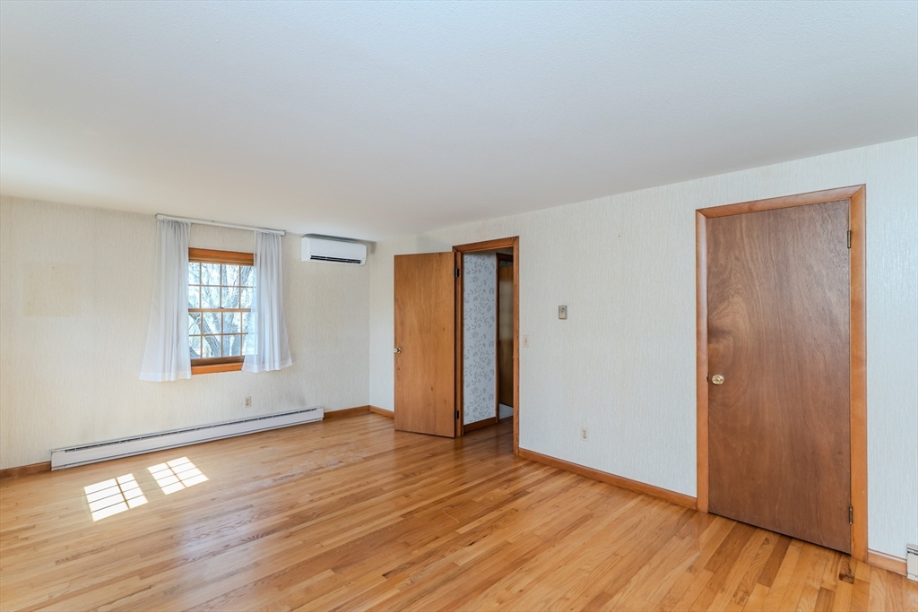 199 Glendale Road Amherst, MA 01002 - Photo 39 of 42 an empty room with wooden floor and windows