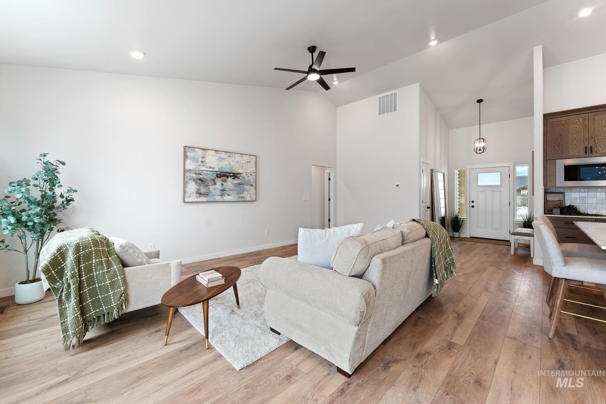 2220 Great Basin Way Burley, ID 83318 - Photo 12 of 39 Living room featuring light wood finished floors, ceiling fan, vaulted ceiling, and recessed lighting