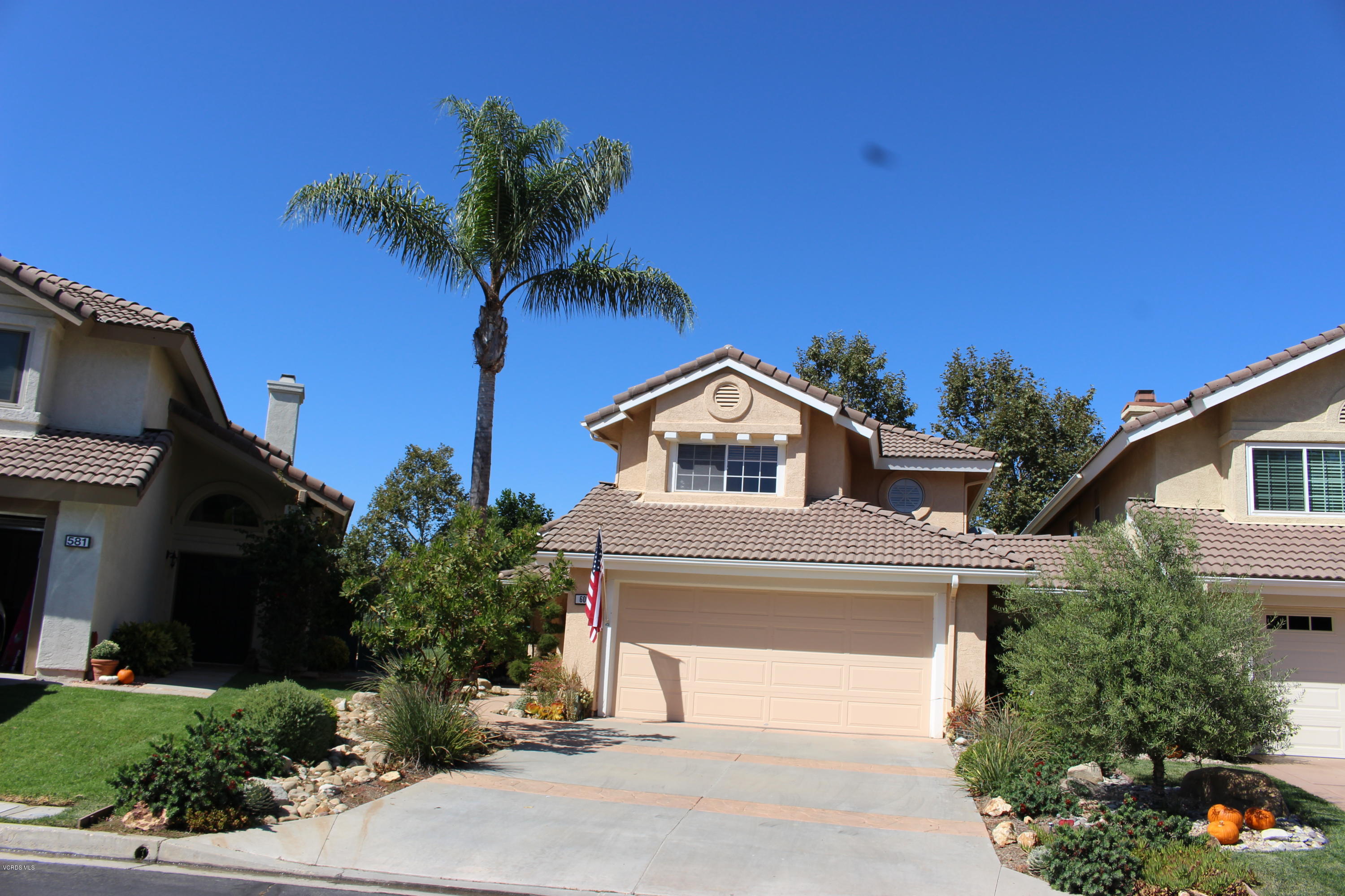 605 Galloping Hill Road Simi Valley, CA 93065 - Photo 2 of 35 a front view of a house with a yard and garage