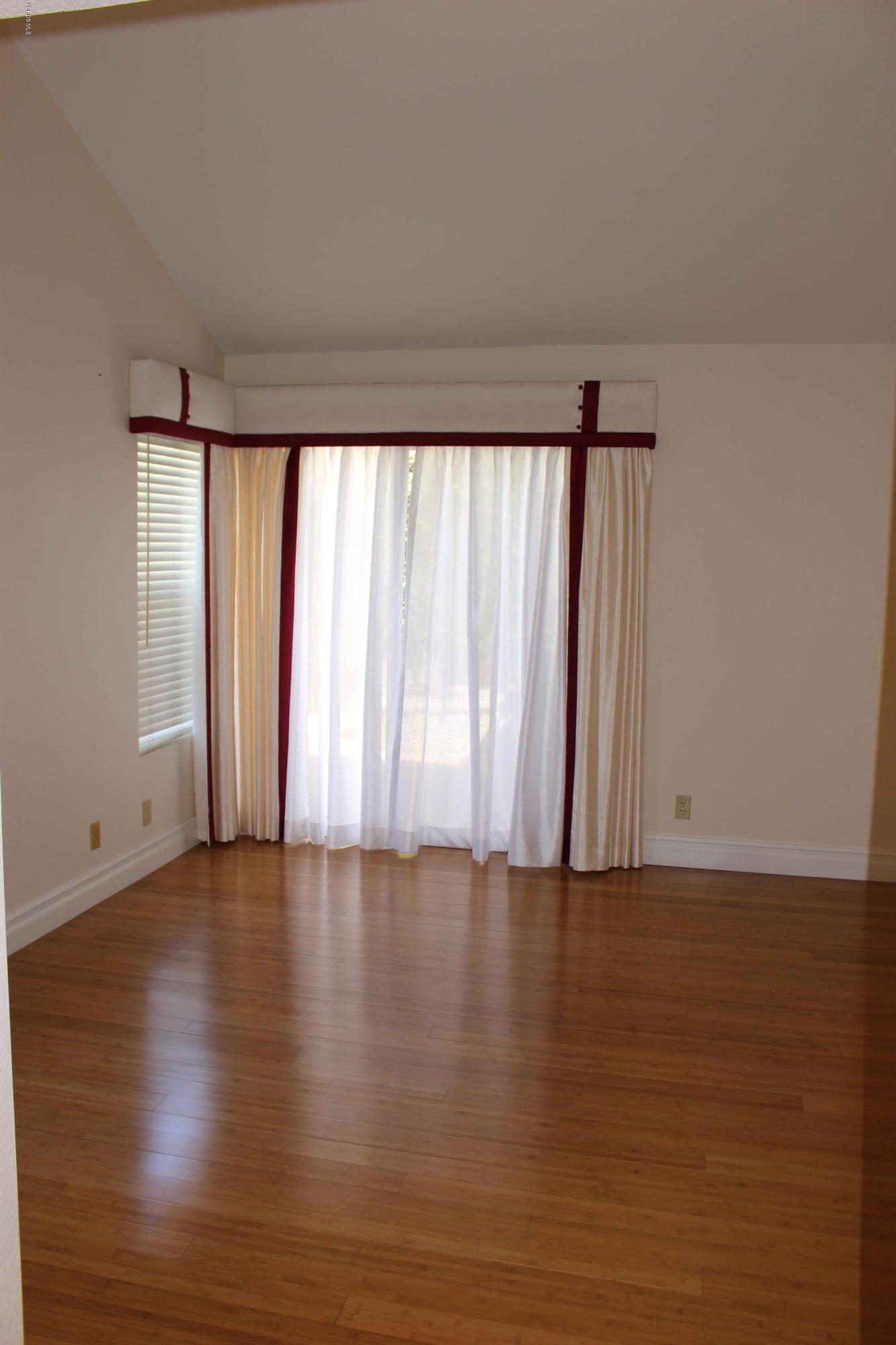 605 Galloping Hill Road Simi Valley, CA 93065 - Photo 13 of 35 a view of an empty room with wooden floor and a window