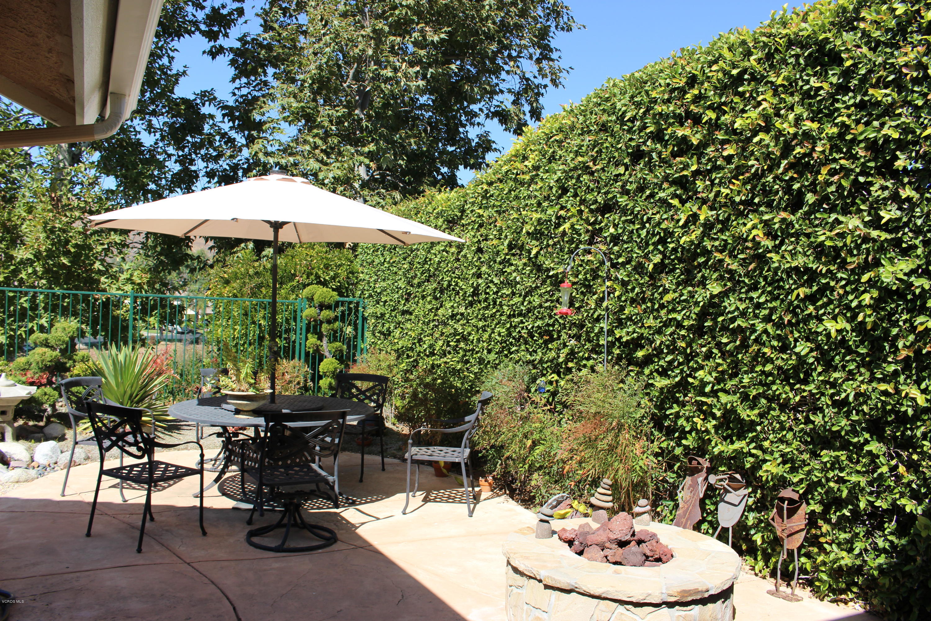 605 Galloping Hill Road Simi Valley, CA 93065 - Photo 26 of 35 a view of a patio with table and chairs and potted plants