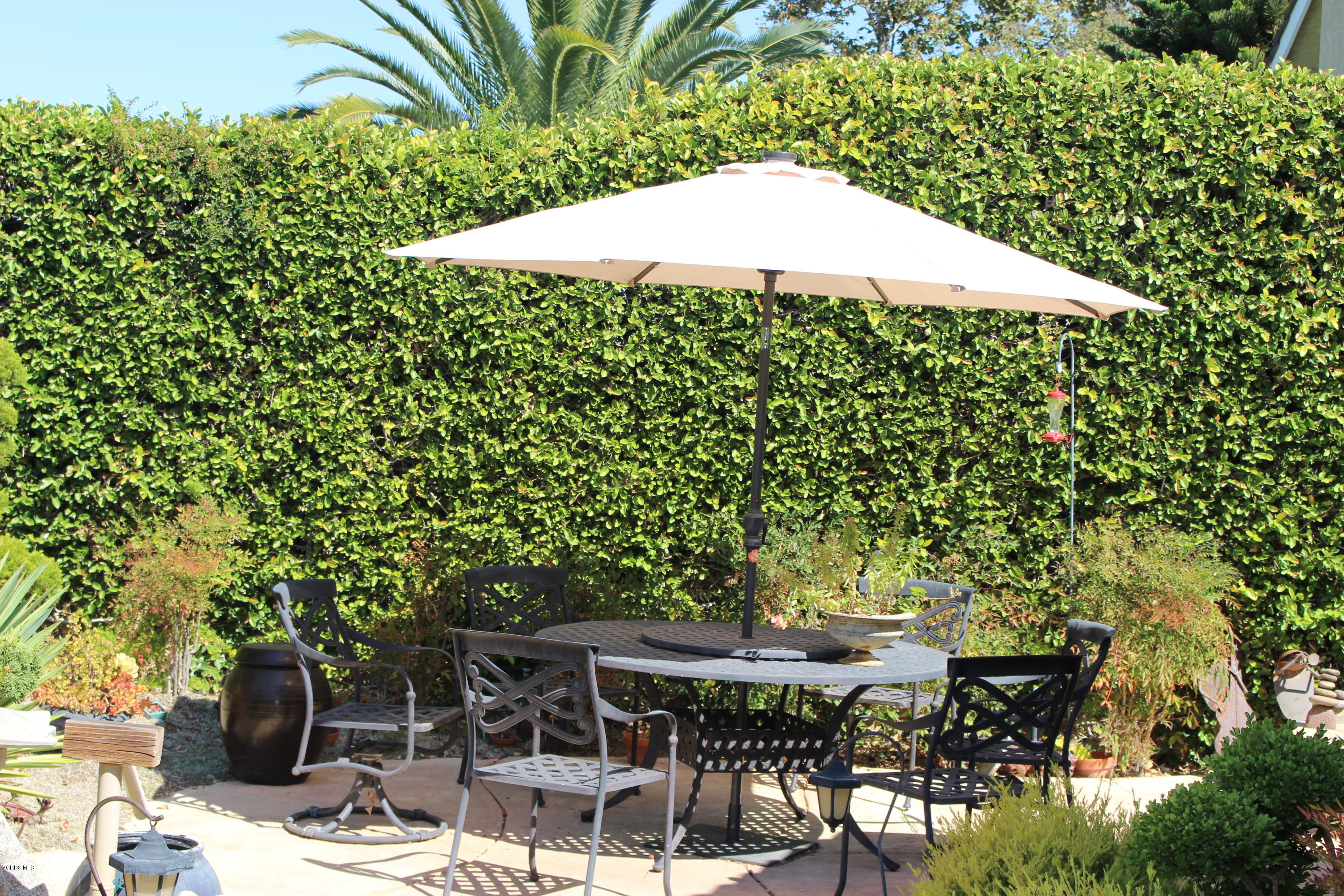 605 Galloping Hill Road Simi Valley, CA 93065 - Photo 29 of 35 a patio with table and chairs and potted plants